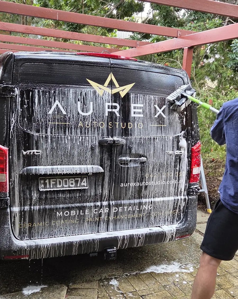 The ceramic coated Aurex Auto Studio work van being washed in a driveway
